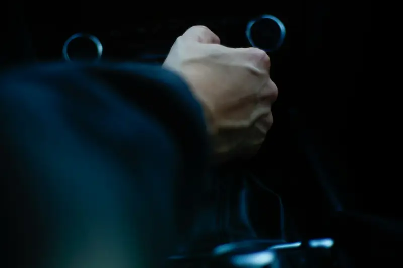 Förarens hand i en bilinteriör